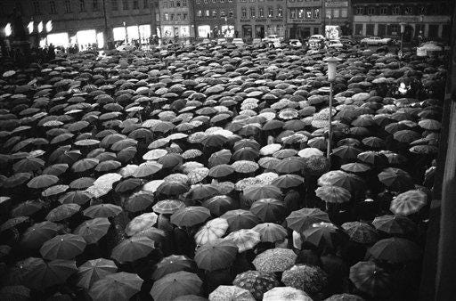 A vast sea of umbrellas hides a section of the crowd of 4,000 that gathered in the rain in the town square in Bamberg, West Germany, on June 17, 1965, for a rally of atonement. The atonement followed the daubing of antisemitic slogans on tombstones in the town's Jewish cemetery.