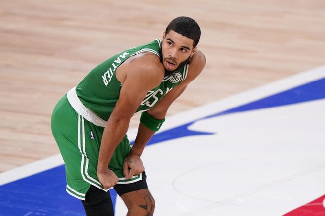 Boston's Jayson Tatum stands on the court during a time out in the second half of Game 4 of Wednesday' Eastern Conference final against the Miami Heat.