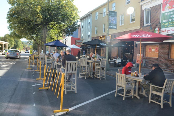 Metal gates separate diners from traffic on Crystal Street in East Stroudsburg. The safety of moving outdoor dining into roads and into parking spaces was called into question during a Stroudsburg Borough Council meeting that focused on what type of barriers should be required.
