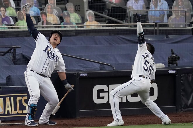 Tampa Bay's Randy Arozarena (56) celebrates his two-run home run against the Houston Astros with Ji-Man Choi during the first inning of Game 7 of the American League Championship Series, Saturday, Oct. 17, 2020.
