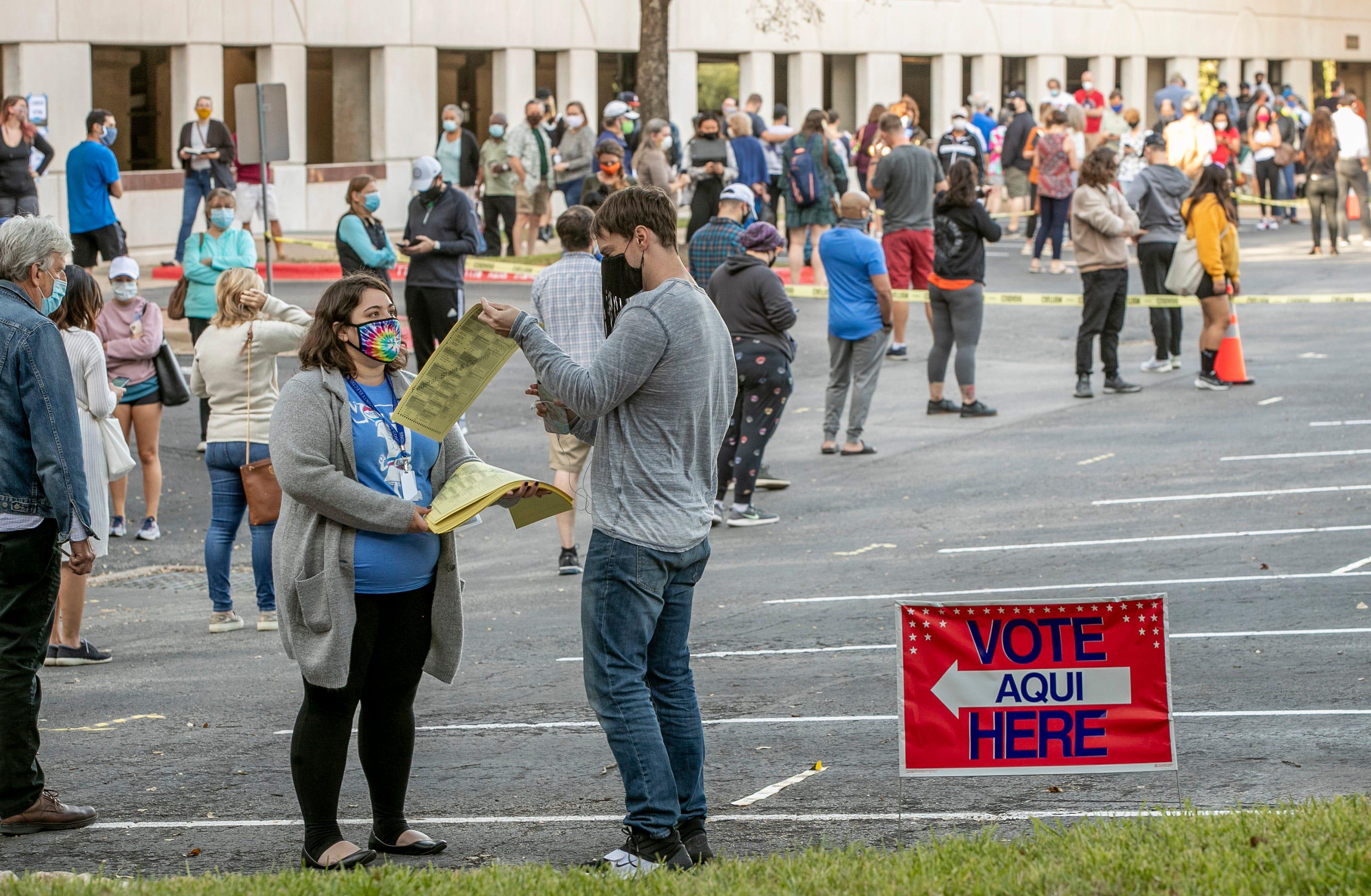 People wait in a long line on the first day of early voting in October at the Renaissance Austin Hotel.