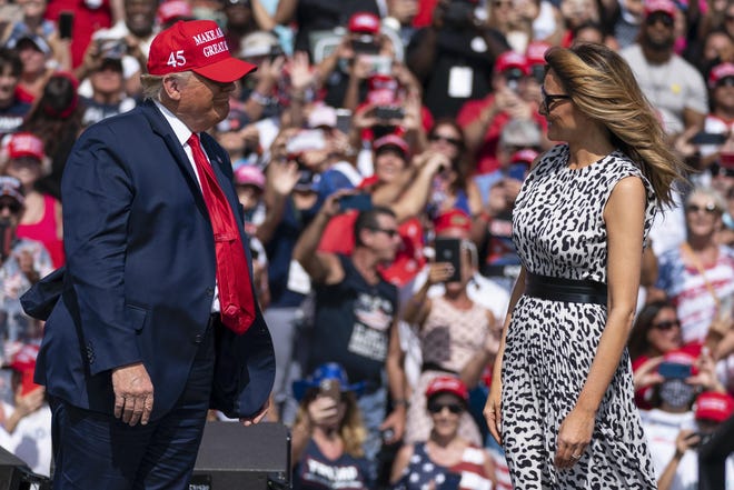 President Donald Trump smiles at first lady Melania Trump after she introduced him at a campaign rally Thursday outside Raymond James Stadium in Tampa.