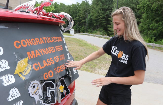 Maynard High School senior Jordan Tucker, 17, finishes decorating her car before she and the rest of the Class of 2020 drove in a "Celebratory Parade for the Class of 2020", Friday, June 5, 2020.