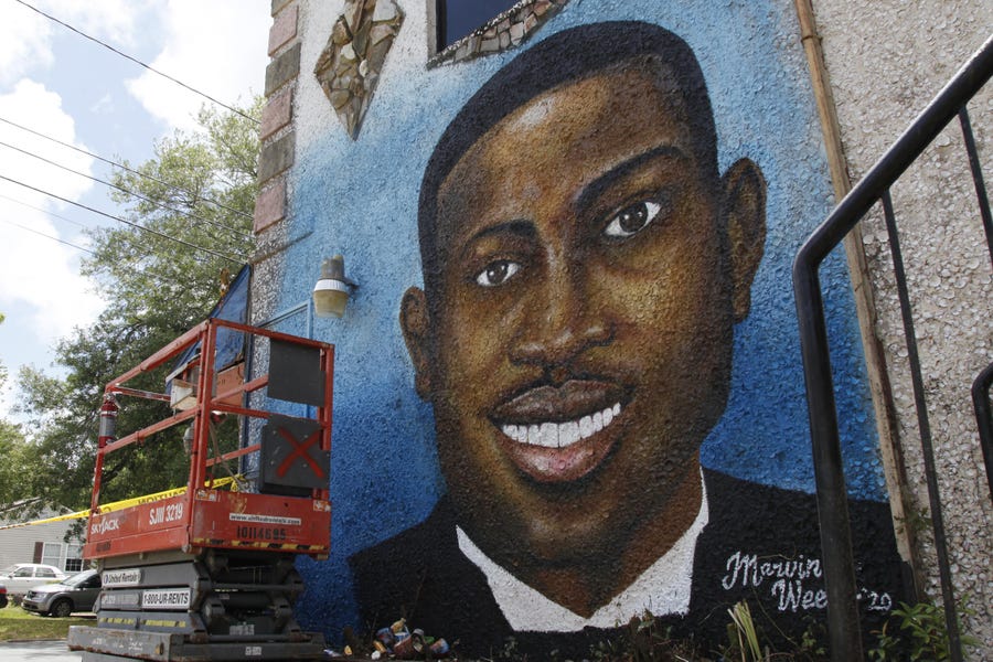 A mural of Ahmaud Arbery is on display in Brunswick, Ga., where the 25-year-old man was shot and killed in February. It was painted by Miami artist Marvin Weeks.