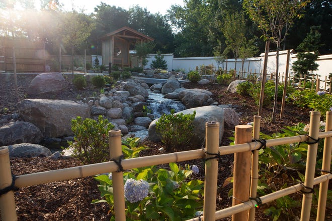 Bamboo fencing lines one of the paths following a stream through Kay's Garden inside the Topeka Zoo.