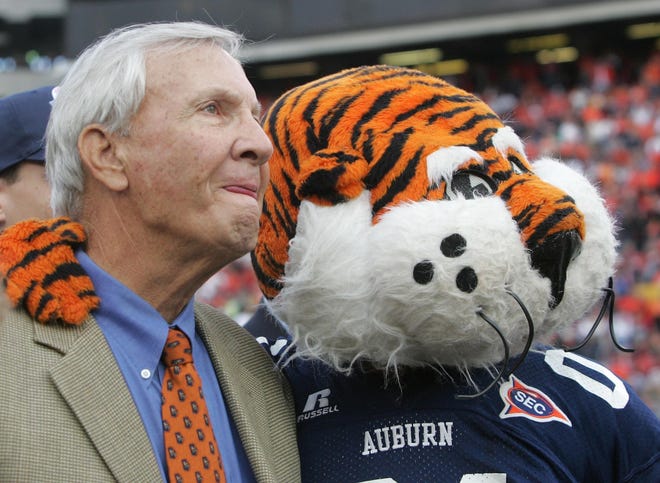 Former Auburn coach Pat Dye watches with Auburn's mascot a video tribute to his career before the start of the Iron Bowl against Alabama, Saturday Nov. 19, 2005 in Auburn, Ala. The school re-named the playing field after him.