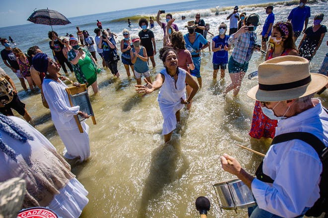 Participants dance in the ocean as they celebrate during the annual Juneteenth Wade In, Friday morning, June 19, 2020 on Tybee Island. Juneteenth is a celebration of the day Union soldiers reached Galveston, Texas, with the news that the war had ended and enslaved people were free.
