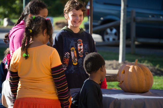 Kids talk to the talking pumpkin at Shelby City Park's 2019 Halloween event.