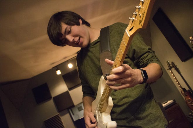 Riley Senne shows off his riffing skills Saturday afternoon in his basement studio. The Seaman High School senior is set to attend Berklee College of Music, one of the nation's top music institutions, next fall.