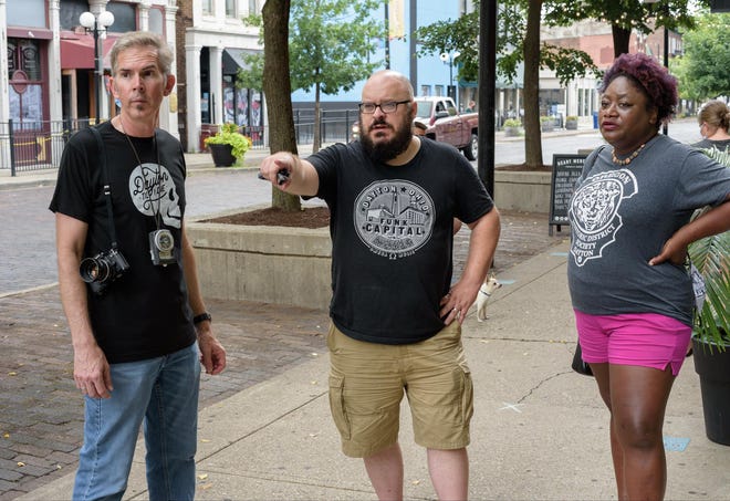 Dayton Daily News journalists Anthony Shoemaker, center, and Amelia Robinson and former photojournalist Ty Greenlees point out locations where the 2019 mass shooting in the Oregon District unfolded.