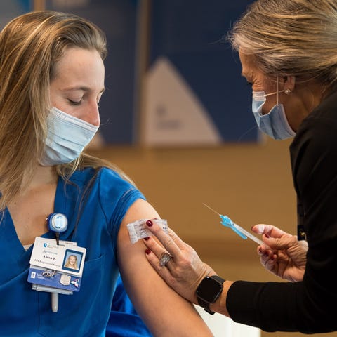 Nurse Debbie Mahoney administers a COVID-19 vaccin