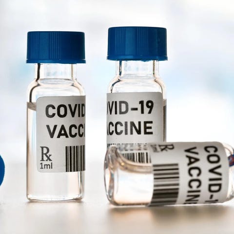 Four vials of COVID-19 vaccine.