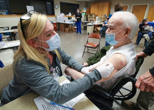 Nurse April Israel administers the second dose of COVID-19 vaccine to Don Robinson, 105, at Norton Audubon Hospital in Louisville, Ky., on Feb. 12. Robinson was 3 years old when the Spanish flu killed 675,000 people in the USA. Robinson hopes to visit with family in Idaho, California and Florida he hasn't seen since the coronavirus pandemic started.