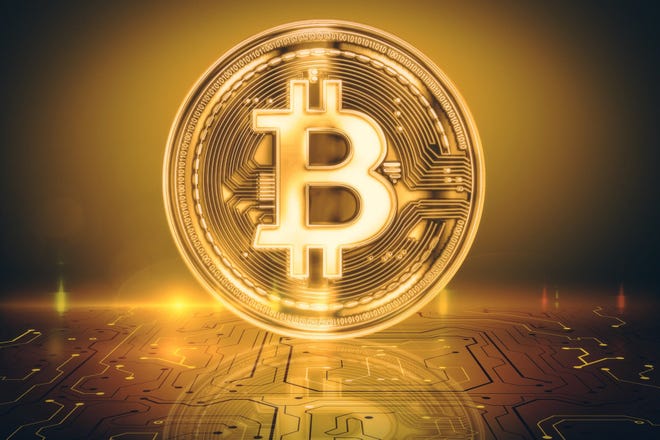 A bitcoin logo on a coin.