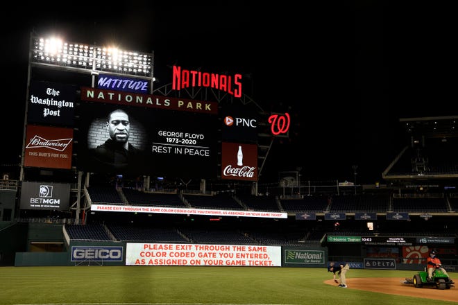 The scoreboard shows an image of the George Floyd after a baseball game between the Washington Nationals and the St. Louis Cardinals, Tuesday, April 20, 2021, in Washington. The Nationals won 3-2. (AP Photo/Nick Wass)