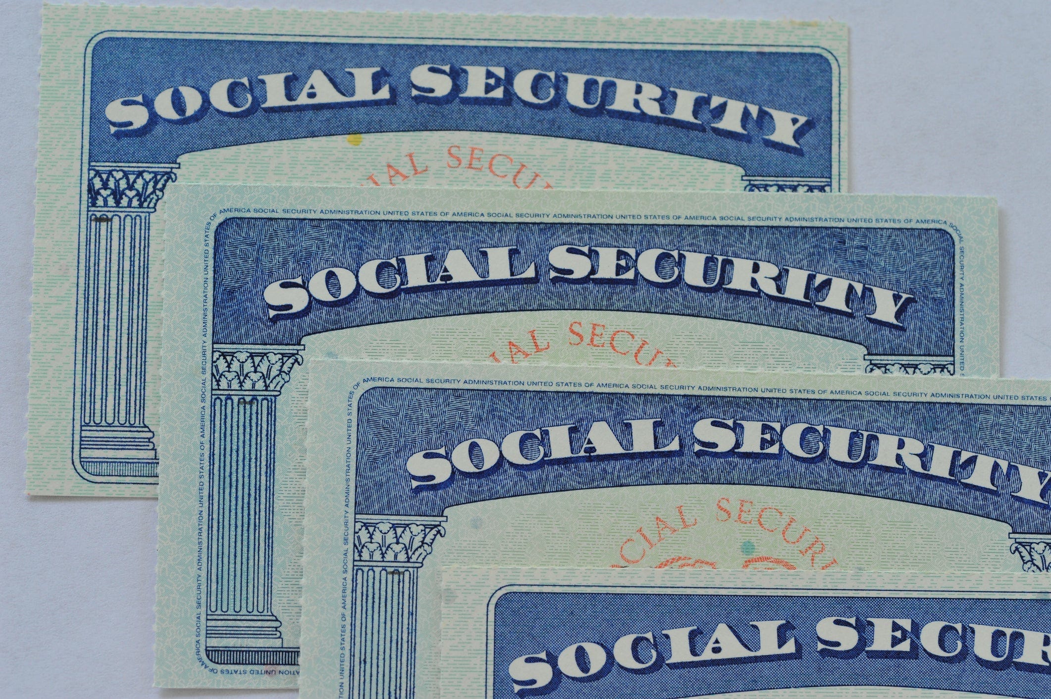 Four Social Security cards resting on each other