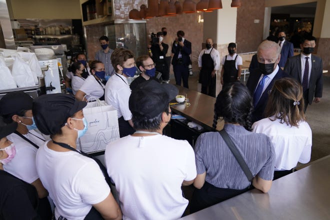 President Joe Biden talks with employees during a visit to Taqueria Las Gemelas restaurant Wednesday in Washington.