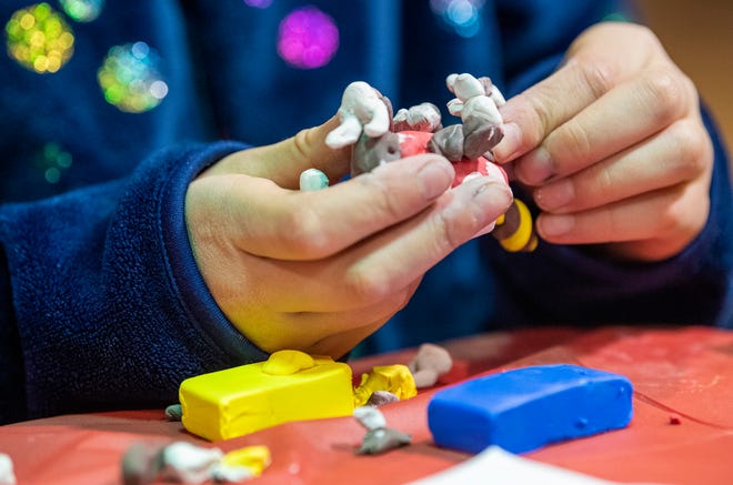 Poppy Chaveas makes a clay tiger monkey, her invention, during a class at ArtBeat Community Arts Center in College Mall taught by Rachael Himsel Saturday, February 15, 2020. (Rich Janzaruk / Herald-Times)