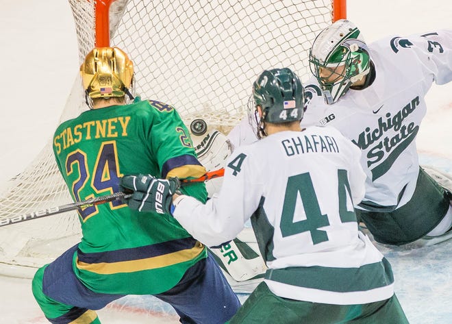 Notre Dame’s Spencer Stastney (24) watches a puck get past Michigan State’s John Lethemon (31) as Butrus Ghafari (44) defends Feb. 29, 2020 at the Compton Family Ice Arena in South Bend. The Irish and the Spartans resume their Big Ten rivalry this weekend in South Bend.
(South Bend Tribune file photo)