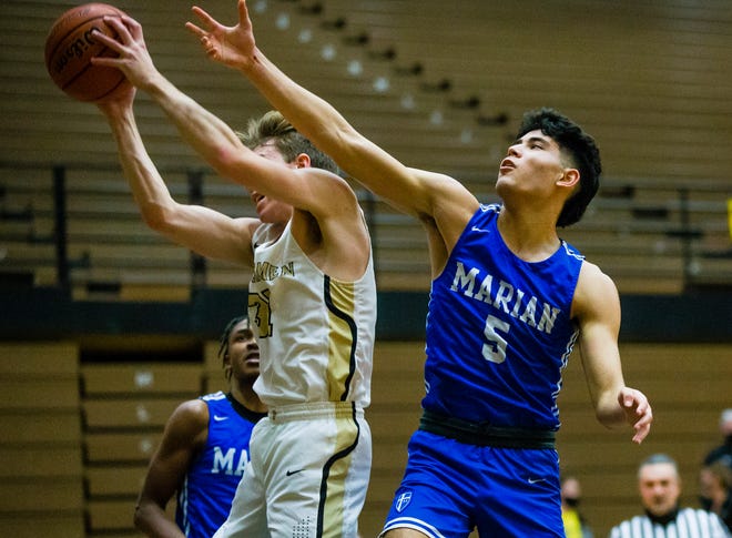 Marian's Kaleo Kakalia (5), shown is this Jan. 22 2021 file photo going against Penn's Caleb Applegate, scored 17 points in a 66-53 win at South Bend Riley Friday night.