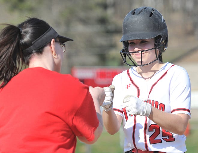 Conemaugh Township freshman leadoff hitter Sarah Favreau gets a fist bump from first base coach Tara Kimmel after a third inning single to load the bases against Meyersdale Friday afternoon in Davidsville.