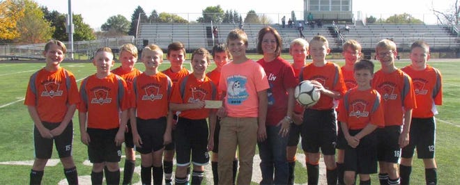 Pictured are youth players representing Somerset Area Little Eagles Soccer and Somerset Area Soccer Club with Olivia’s mother Rebecca Van Deusen-Shaulis and brother Cash Shaulis. Front row, from left: Micah Flower, Kahne Foltz, Jared Walker, Tanner Wassilchalk, Cash Shaulis, Rebecca Van Deusen-Shaulis, Logan Seslow, Cole Johnson, Toby Walker. Back row, from left: Matthew Shaffer, Liam Egal, Anthony Knecht, Miles Gnagey-Davis, Jeremiah Foster and Ian Shoff.