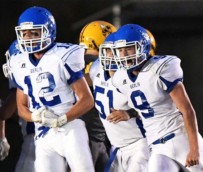 Berlin’s Isaiah Paul (12), Drew Boyer (51) and Riley Simpson (9) celebrate after a play against Ferndale last week in high school football action.