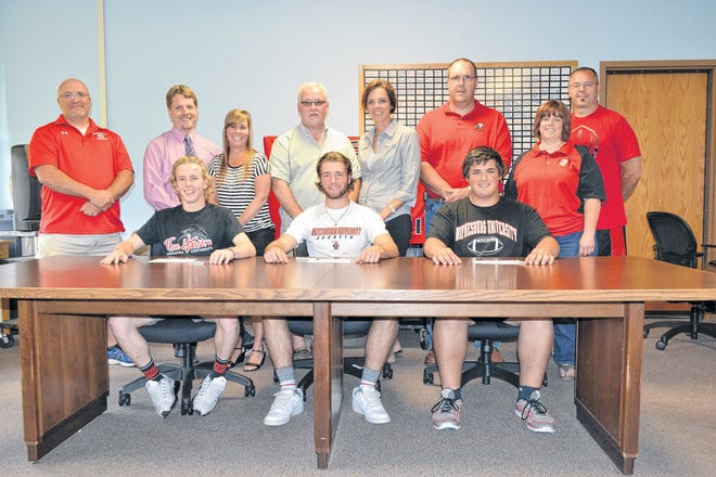 Conemaugh Township seniors in front from left: Ben Wilson, Luke Maurer and Steve Summits announce their intentions to continue their athletic careers at the collegiate level. Looking on in back are: head soccer coach Christopher Miller, Chuck and Valerie Wilson, Matt and Lisa Maurer, Scott and Mary Summits and head football coach Sam Zambanini.