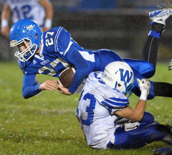 Windber’s Shadoe Smith brings down Cole Booth of Berlin after a run on Friday night. 