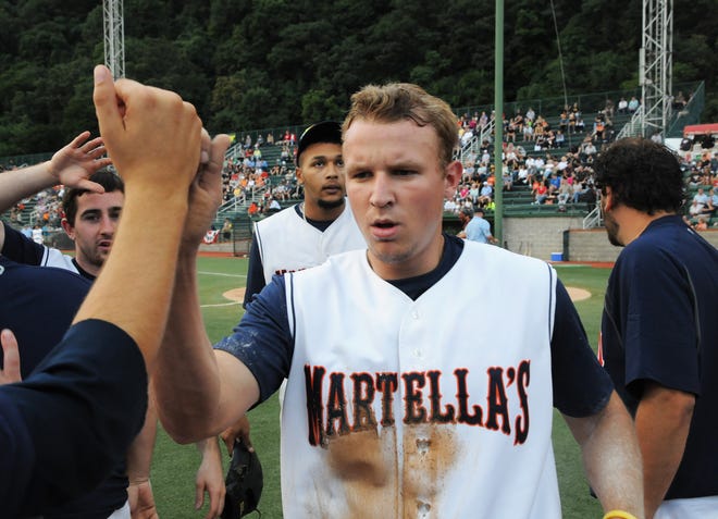 Dillon Boyer of Martella’s Pharmacy is congratulated by his teammates after scoring in the bottom of the first inning against Buffalo in the AAABA National Tournament last year at Point Stadium. Boyer was named the 2016 Johnstown Junior League MVP.