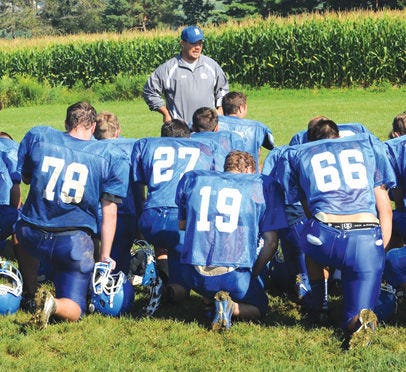 Berlin Brothersvalley head football coach Doug Paul adresses his team during training camp last year. High school football camps officially begin Monday throughout Pennsylvania. Other fall sports, such as soccer, volleyball and golf, can start practicing as well.