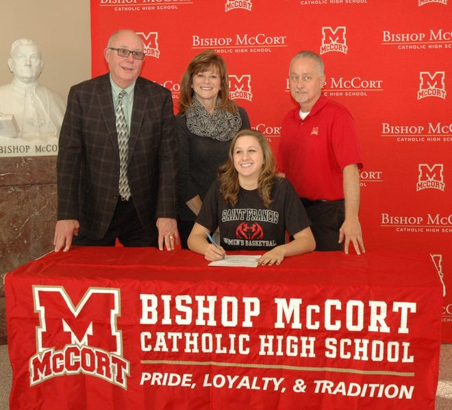 Haley Thomas signs a national letter of intent to play basketball at St. Francis University. She is pictured with, standing from left, Bishop McCort girls basketball coach John Hahn and her parents Mary and Tim Thomas.