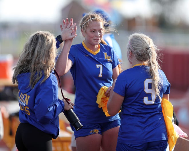 Aberdeen Central's Megan Fastenau, center, celebrates with a teammate as she talks to Kensington Eckhoff, right, on the sideline during Thursday's semi-final soccer match against Sioux Falls Lincoln at Swisher Field. American News photo by John Davis taken 10/17/2019