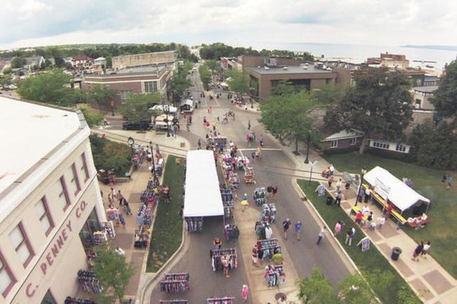 An overhead view of Petoskey's Sidewalk Sales on Mitchell Street shows people shopping through the streets of downtown Petoskey.