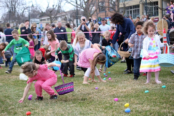 A swarm of kids run towards Easter eggs during a previous egg hunt in Charlevoix's East Park.
