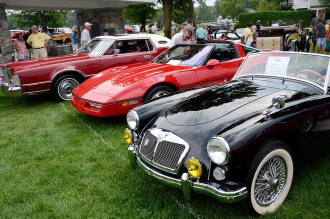 People mill around the cars on display during the Harbor Springs Car Festival in a previous year.