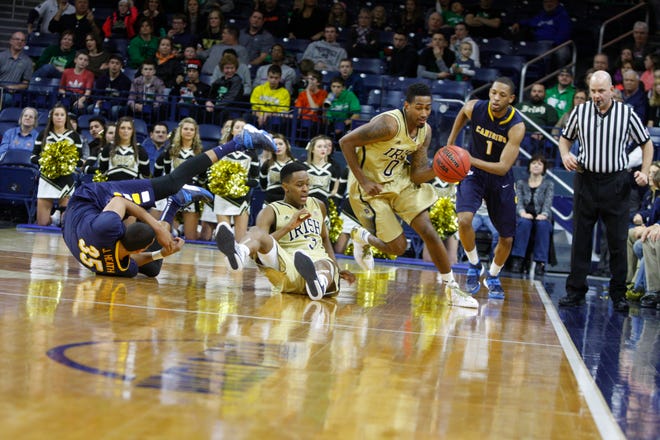 Notre Dame's Eric Atkins (0) dribbles upcourt after getting a rebound past Canisius's Jordan Heath (35) Zach Lewis(1) and Notre Dame's V.J. Beachem (3) during 2nd half action at the Purcell Pavilion at the Joyce Center Sunday, December 29, 2013. Notre Dame won the game 87-81 in overtime. South Bend Tribune/ MIKE HARTMAN 