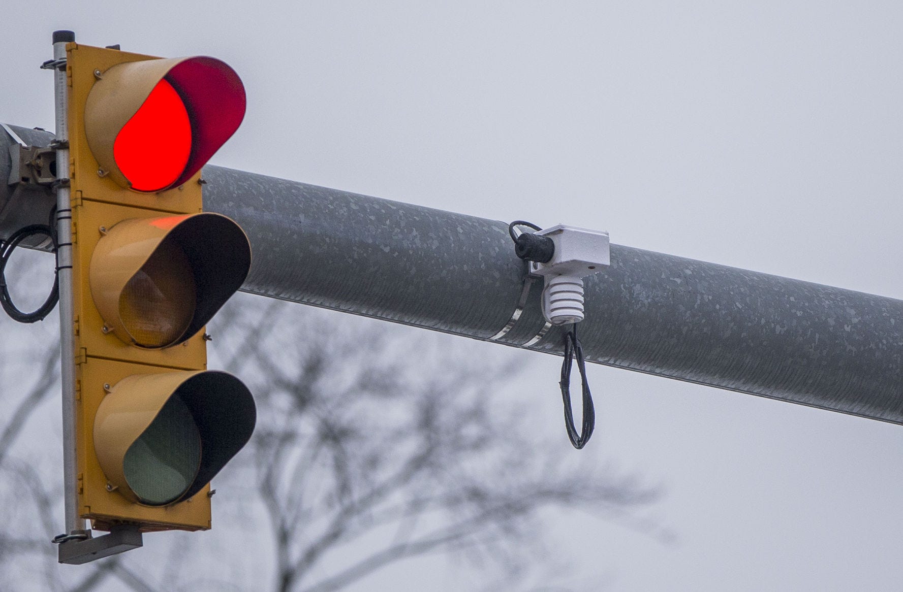 A Road Weather Information System hangs next to a traffic signal at the intersection of Eddy and Cedar streets in South Bend.