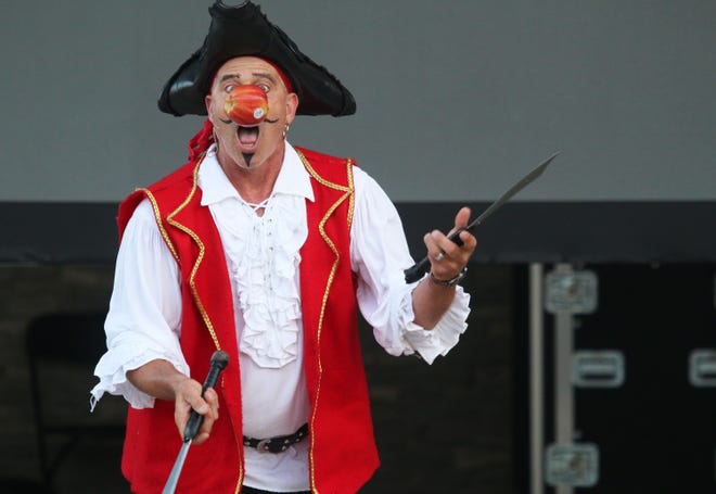 Tommy Tropic is seen juggling knives while trying to take a bite out of an apple during the 2018 Charlevoix Venetian Festival. Tropic is the mastermind behind the upcoming Up North Busker Fest in East Jordan.