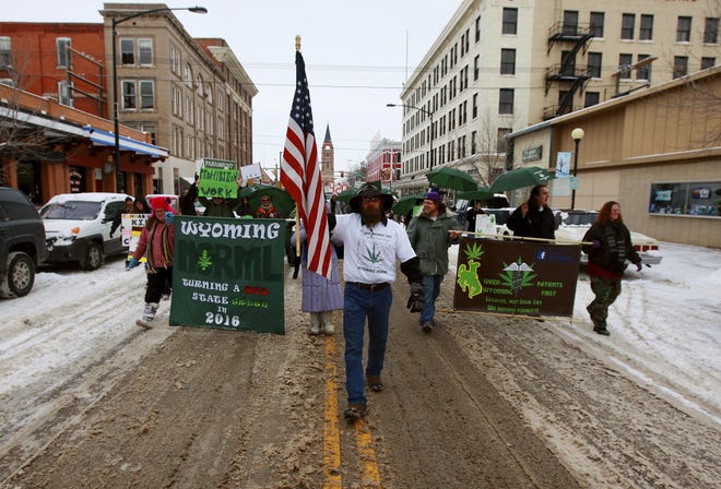 A group of people march in Cheyenne during a 2014 demonstration urging the state of Wyoming to legalize marijuana.