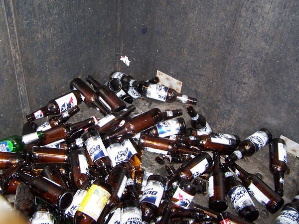 Glass bottles, crushed cans and plastic bottles for recycling