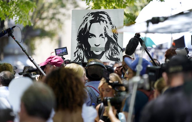 A portrait of Britney Spears looms over supporters and media members Wednesday outside a court hearing concerning the pop singer’s conservatorship in Los Angeles.