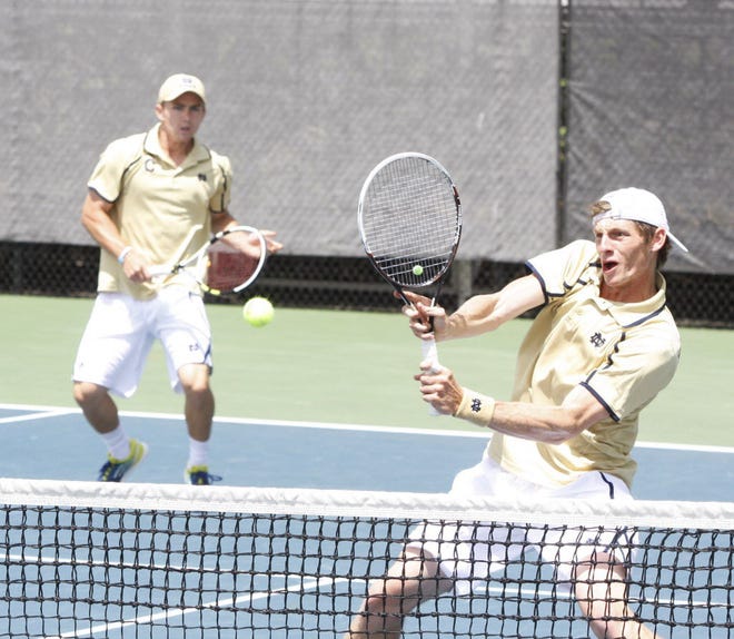 Notre Dame’s Alex Lawson prepares Sunday to return a shot against Mississippi in the second Round of the 2014 NCAA Division I tennis championships as his No. 1 doubles partner Greg Andrews looks on. (Tribune File Photo)