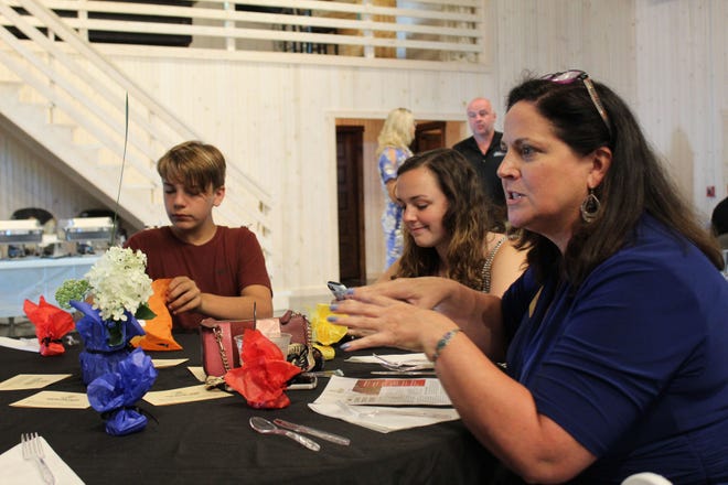 From left, Lucas, Marjorie and Jennifer Abrell engage in conversation at their table during the Spencer Main Street Annual Dinner on Monday evening. (Nicole DeCriscio / Spencer Evening World)