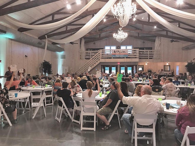 The annual Purr &amp; Fur Banquet to Benefit the Owen County Humane Society was a hit, raising $18,465 to help out our local four-legged friends. Attendees at the event can be seen bidding on items and having a good time. (Submitted / Spencer Evening World)