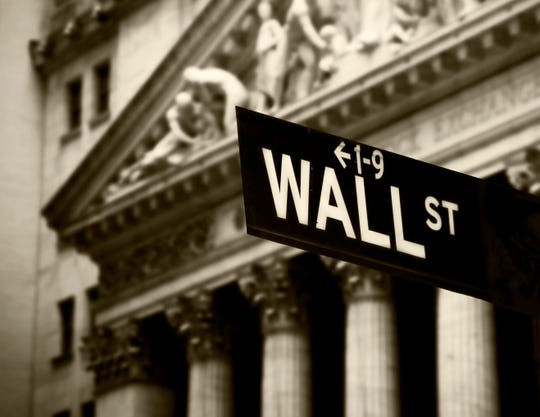 Wall Street sign in front of New York Stock Exchange.