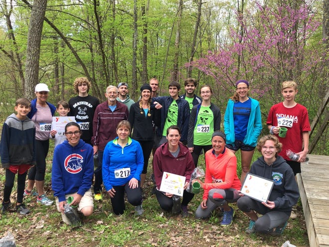 The YMCA/Friends of McCormick’s Creek 5K run winners include, front row, from left: Gloria Lopez, Cindy Hanson, Kindria Martin, Heather Poynter and Emma Callahan (overall female winner). Back row: Caleb Winders (overall male winner), Cindy Ellinwood, Noah Somes, Jeff Ulman, Lance Daugherty, Scott Wickersham, Susan Randall, Terry Carlson, Cole Burgess, Donovan Myers, Shyann Raser, Jill Vance and Xavier Kopsho. (Submitted / Spencer Evening World)
