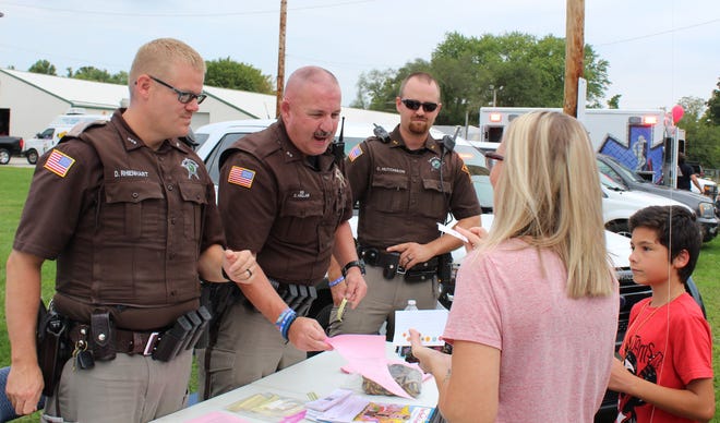 Owen County Sheriff’s Deputy Daniel Rhienhart, Charlie Hallam and Caleb Hutchison are pictured as they interact with those in attendance at the 2019 Kids Connect event Saturday. (Nicole DeCriscio Bowe / Spencer Evening World)