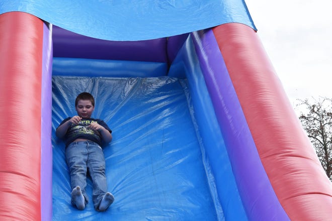Draben Haygood slides down the bouncy slide at the Owen County Public Library’s Block Party on Monday. It was the second year for the event, which kicked off National Library Week. (Nicole DeCriscio / Spencer Evening World)
