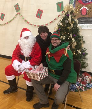 Gosport Elementary principal Carol Watson poses with Santa and one of his elves during the recent GES Christmas program. (Submitted / Spencer Evening World)